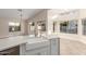 Open-concept kitchen with an island sink and views of the bright living room and outdoor spaces at 445 W Gary Ave, Gilbert, AZ 85233