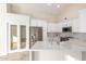 Bright kitchen with white cabinetry, stainless steel appliances, and a spacious center island, great for entertaining at 445 W Gary Ave, Gilbert, AZ 85233