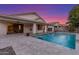 Beautiful backyard pool with travertine patio, covered porch, and lush landscaping at 445 W Gary Ave, Gilbert, AZ 85233