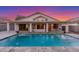 Inviting backyard pool with water feature, covered patio, and beautiful sunset views at 445 W Gary Ave, Gilbert, AZ 85233