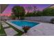 Backyard pool surrounded by stone pavers, artificial turf, and privacy landscaping at 445 W Gary Ave, Gilbert, AZ 85233