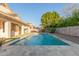 Outdoor pool surrounded by lush greenery, rock landscaping, and travertine patio at 445 W Gary Ave, Gilbert, AZ 85233