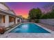 Backyard pool featuring stone tile surround and views of the colorful sunset at 445 W Gary Ave, Gilbert, AZ 85233
