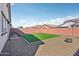 Large, private backyard with desert landscaping, artificial grass, and ample space at 45734 W Sky Ln, Maricopa, AZ 85139