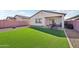 Private backyard oasis featuring artificial grass, patio, and space for outdoor entertaining at 45734 W Sky Ln, Maricopa, AZ 85139