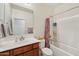 Well-lit bathroom featuring a vanity, toilet, and a combined tub and shower at 45734 W Sky Ln, Maricopa, AZ 85139