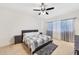 Bright bedroom featuring a quilted bed, soft lighting, and carpeted floors at 45734 W Sky Ln, Maricopa, AZ 85139