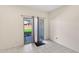Bright, vacant room with sliding glass doors to the backyard at 45734 W Sky Ln, Maricopa, AZ 85139