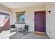 Inviting front porch with seating area and stylish front door at 45734 W Sky Ln, Maricopa, AZ 85139