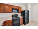Kitchen featuring wooden cabinets and black appliances, including a gas range at 45734 W Sky Ln, Maricopa, AZ 85139