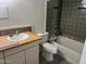 Bathroom featuring a vanity with wood countertop, toilet, and shower with gray tile at 4727 E Lafayette Blvd # 117, Phoenix, AZ 85018