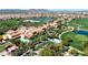 Stunning aerial view of a resort-style community pool surrounded by palm trees and lush greenery at 500 E Watermelon Ln, Queen Creek, AZ 85140