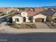 Charming single-story home with a well-manicured front yard and a private two-car garage at 500 E Watermelon Ln, Queen Creek, AZ 85140