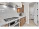 Modern kitchen featuring sleek stainless steel appliances, a gas cooktop, and stylish cabinetry at 500 E Watermelon Ln, Queen Creek, AZ 85140