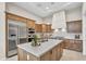 Gourmet kitchen featuring stainless steel appliances and custom cabinetry providing ample storage at 500 E Watermelon Ln, Queen Creek, AZ 85140