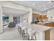 Open-concept kitchen featuring a large island, modern barstool seating, and stainless steel appliances at 500 E Watermelon Ln, Queen Creek, AZ 85140