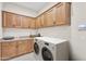 Spacious laundry room with modern appliances, ample cabinet space, and countertops at 500 E Watermelon Ln, Queen Creek, AZ 85140