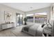Bright main bedroom featuring neutral walls, stylish decor, large windows, and access to a private outdoor space at 500 E Watermelon Ln, Queen Creek, AZ 85140