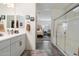 Bright bathroom with double sinks, white cabinets, and a glass-enclosed shower at 5140 E Desert Forest Trl, Cave Creek, AZ 85331