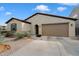 Well-maintained single-story home with two-car garage, neutral stucco and tidy desert landscaping at 5140 E Desert Forest Trl, Cave Creek, AZ 85331