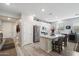 Well-lit kitchen boasting a central island with seating, stainless steel appliances, and sleek white cabinetry at 5140 E Desert Forest Trl, Cave Creek, AZ 85331