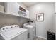 Functional laundry room equipped with washer, dryer, and storage cabinets at 5140 E Desert Forest Trl, Cave Creek, AZ 85331