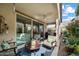 Comfortable covered patio featuring stylish seating, ceiling fan and lush landscaping at 5140 E Desert Forest Trl, Cave Creek, AZ 85331