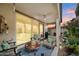 Covered patio featuring comfortable seating, an outdoor ceiling fan and a grill at 5140 E Desert Forest Trl, Cave Creek, AZ 85331