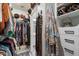 Walk-in closet with custom shelving, hanging space, and organized storage solutions at 5140 E Desert Forest Trl, Cave Creek, AZ 85331