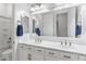 Well-lit bathroom features double sinks, white cabinets with gold hardware, and a large mirror, providing a clean and functional space at 6208 E Lonesome Trl, Cave Creek, AZ 85331
