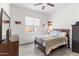 Bright bedroom with a ceiling fan, a comfortable bed, and sports decor, creating a welcoming space at 6208 E Lonesome Trl, Cave Creek, AZ 85331