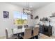 Dining room with stylish light fixture and scenic window view at 6208 E Lonesome Trl, Cave Creek, AZ 85331