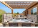 Luxurious hot tub area with a pergola, ideal for unwinding and enjoying the outdoors at 6208 E Lonesome Trl, Cave Creek, AZ 85331