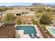Inviting pool area with lounge chairs, desert landscaping and mountain views at 6208 E Lonesome Trl, Cave Creek, AZ 85331