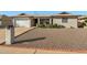 Charming single-story home with a gravel yard, brick accents, and a two-car garage at 6646 E Dodge St, Mesa, AZ 85205