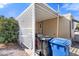 Home exterior featuring a covered porch, lattice accents, and convenient trash receptacles at 7807 E Main St # Cc-85, Mesa, AZ 85207