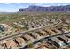 A beautiful community with mountain views and desert landscaping is seen from above, highlighting its peaceful setting at 8117 E Sweet Bush Ln, Gold Canyon, AZ 85118