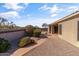 This landscaped backyard features a water fountain, desert plants, and an extended patio, perfect for outdoor living at 8117 E Sweet Bush Ln, Gold Canyon, AZ 85118