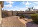 Backyard featuring lush landscaping, gravel, and paved walkway at 8117 E Sweet Bush Ln, Gold Canyon, AZ 85118