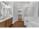 Bright bathroom with vanity, a large soaking tub, and a separate shower for a luxurious experience at 8117 E Sweet Bush Ln, Gold Canyon, AZ 85118