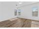 Bright bedroom featuring hardwood floors, recessed lighting, and plenty of natural light through large windows at 8117 E Sweet Bush Ln, Gold Canyon, AZ 85118