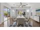 Elegant dining room with sleek furniture, modern lighting, and sliding glass doors to backyard at 8117 E Sweet Bush Ln, Gold Canyon, AZ 85118