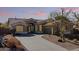 Charming home with a tile roof, desert landscaping, and spacious concrete driveway at 8117 E Sweet Bush Ln, Gold Canyon, AZ 85118