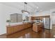 Modern kitchen with stainless steel appliances, a kitchen island, custom cabinetry, and hardwood floors at 8117 E Sweet Bush Ln, Gold Canyon, AZ 85118