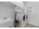 Well-lit laundry room with modern appliances, sink, and ample storage space at 8117 E Sweet Bush Ln, Gold Canyon, AZ 85118