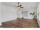Spacious living room featuring hardwood floors, a ceiling fan, and natural light from multiple windows at 8117 E Sweet Bush Ln, Gold Canyon, AZ 85118