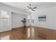 Bright living room with hardwood floors, a ceiling fan, and lots of natural light from multiple windows at 8117 E Sweet Bush Ln, Gold Canyon, AZ 85118