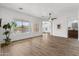 Bright and airy living room featuring hardwood floors, large windows, and views of the landscaped backyard at 8117 E Sweet Bush Ln, Gold Canyon, AZ 85118