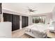 Relaxing main bedroom featuring a ceiling fan, natural light, and spacious closet at 819 E Audrey Ln, Phoenix, AZ 85022