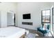 Modern bedroom featuring a fireplace, accent chair, and large window at 8510 S 9Th Dr # 20, Phoenix, AZ 85041